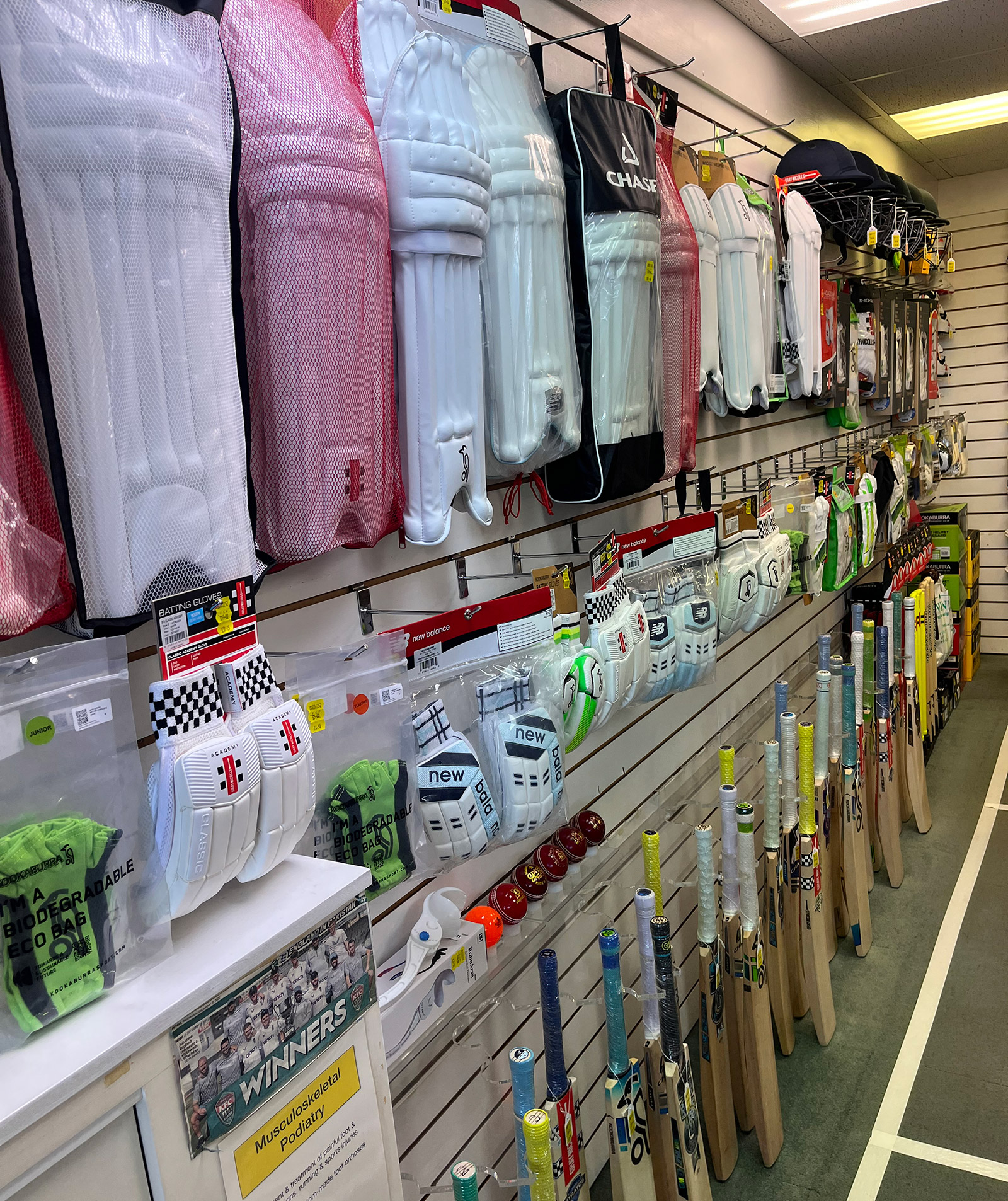 Cricket equipment includes wicket keeper's pads, gloves and bats. Supplied by WINNERS Sports and supplies for cricket.
